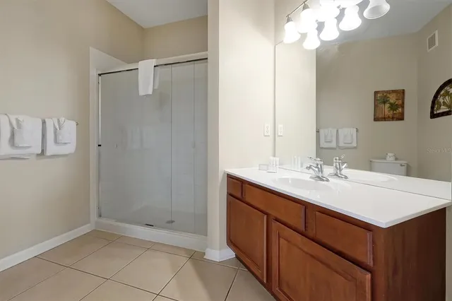 a bathroom with a sink a mirror and a shower