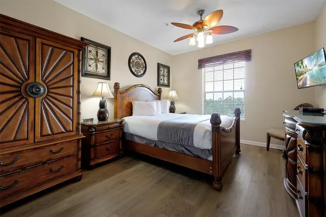 a bedroom with a bed and a chandelier