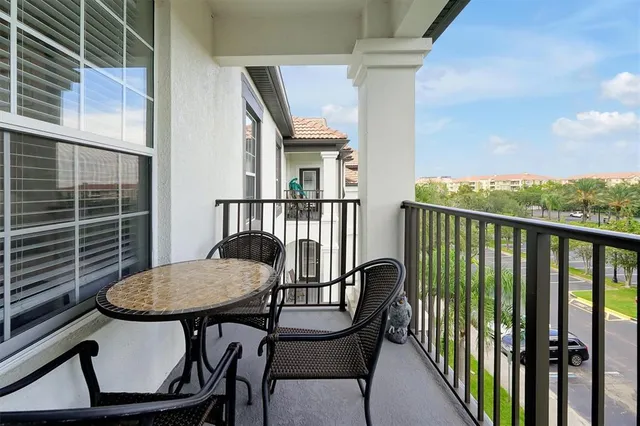 a view of a chair and table in the balcony