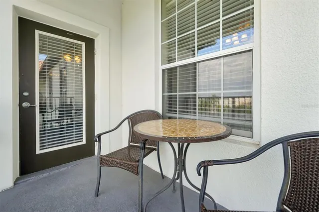 a balcony with table and chairs