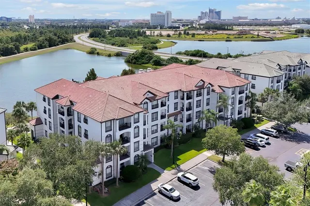 an aerial view of residential houses with outdoor space and river