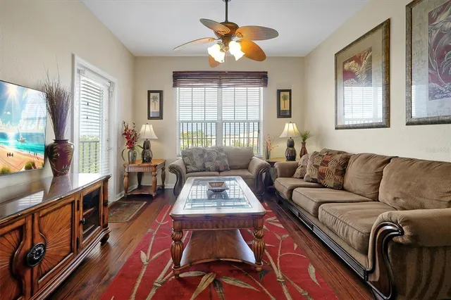 a living room with furniture fireplace and a large window