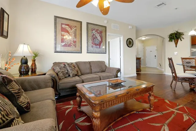 a living room with furniture a couch and a chandelier