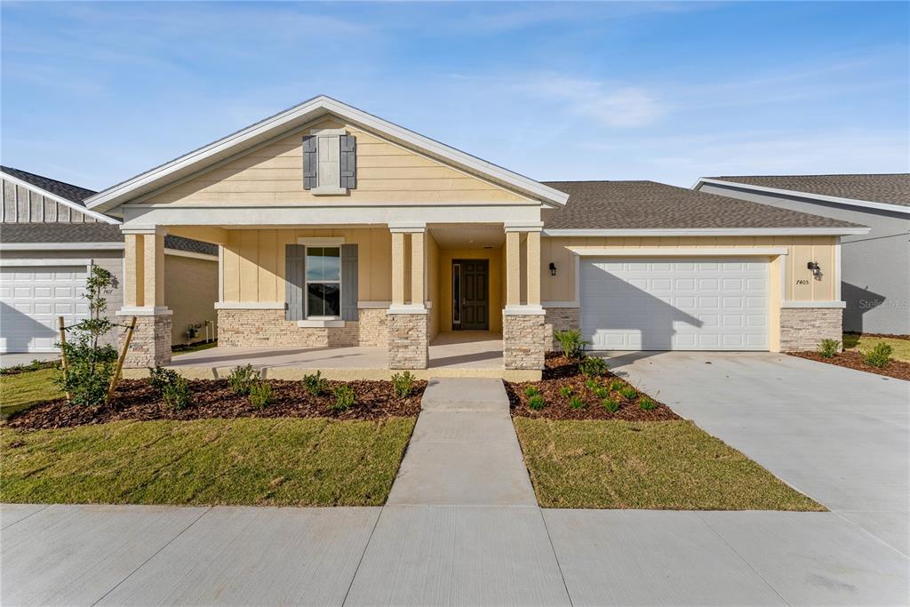 7405 Southwest 61st Street Ocala, FL 34474 - Photo 1 of 46 a front view of a house with garden