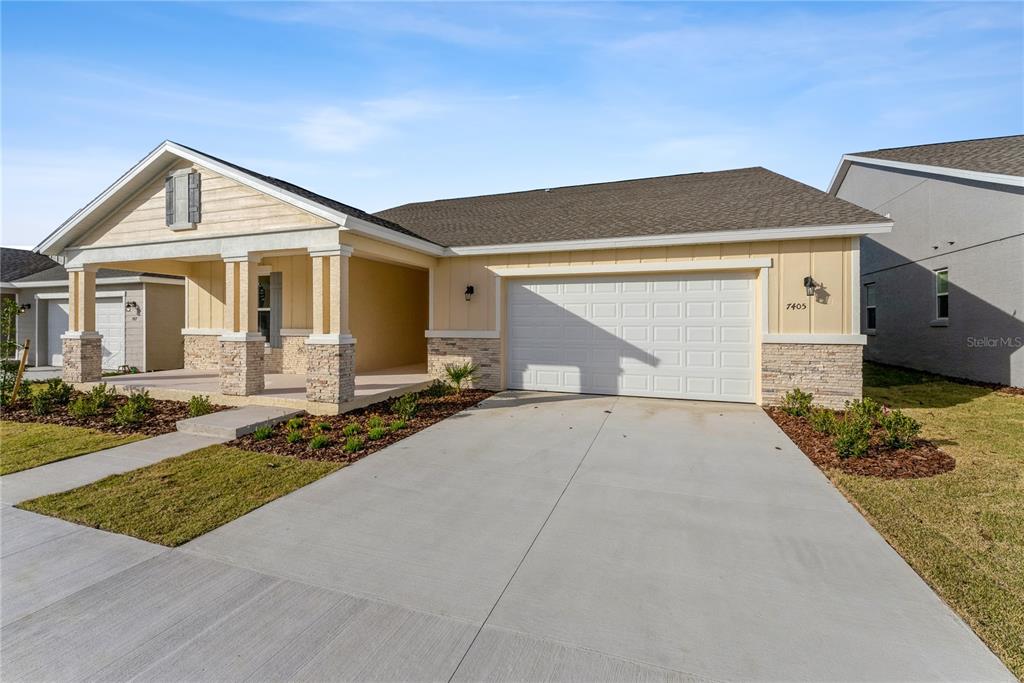 7405 Southwest 61st Street Ocala, FL 34474 - Photo 2 of 46 a front view of a house with a yard and garage