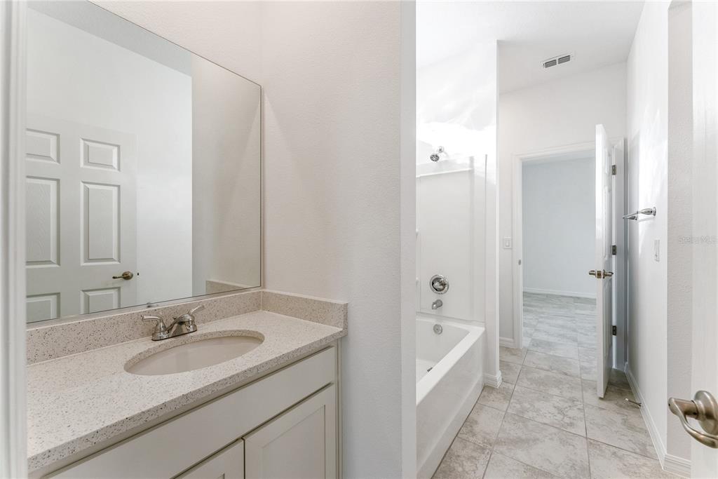 7405 Southwest 61st Street Ocala, FL 34474 - Photo 37 of 46 a bathroom with a tub sink and mirror