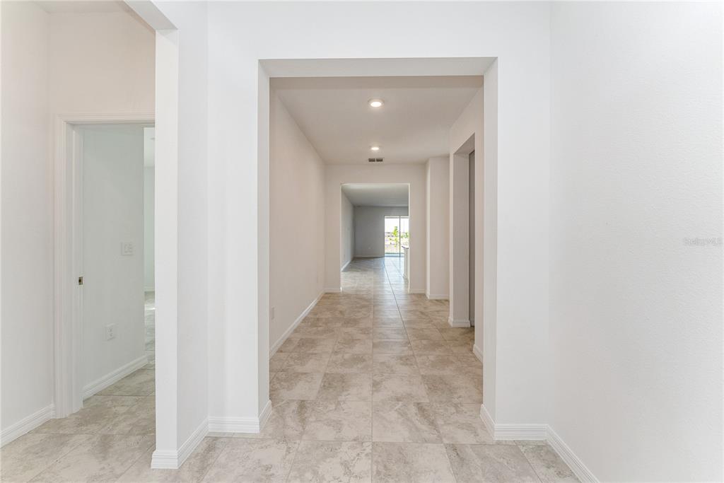 7405 Southwest 61st Street Ocala, FL 34474 - Photo 5 of 46 a view of a hallway with wooden floor
