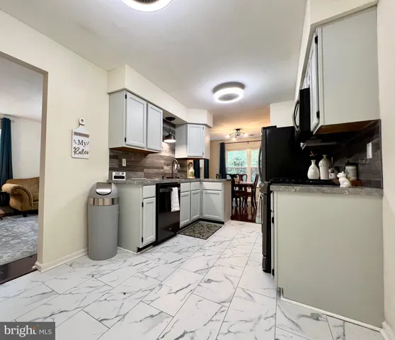 a kitchen with a refrigerator sink and cabinets