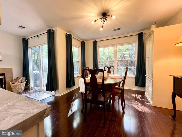 a view of a dining room with furniture window and wooden floor