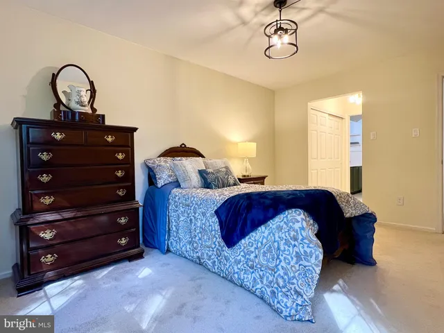 a bedroom with a bed and a dresser