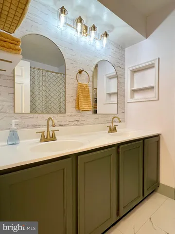 a bathroom with a double vanity sink and mirror