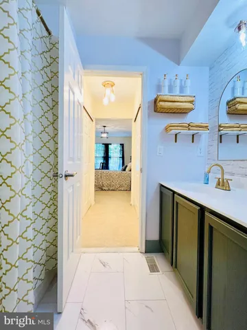 a hallway with a sink and cabinets