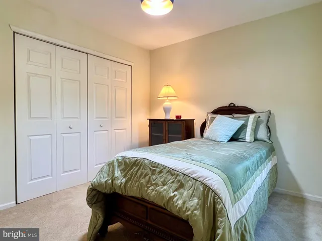a bedroom with a bed and lamps