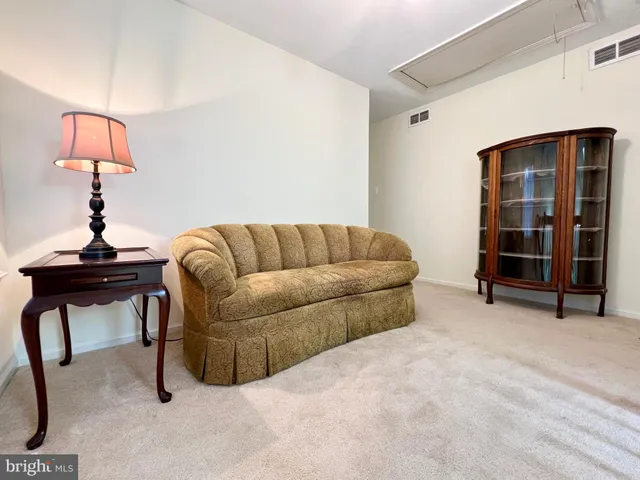 a living room with furniture a lamp and a window