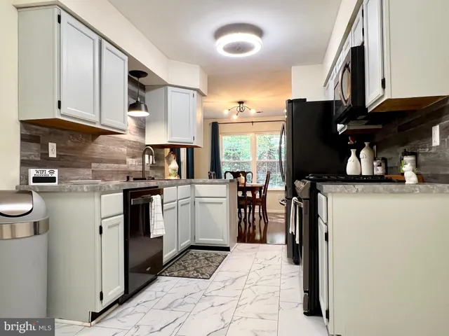 a kitchen with a sink appliances and cabinets