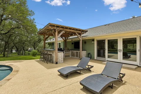 a view of a patio with table and chairs and potted plants