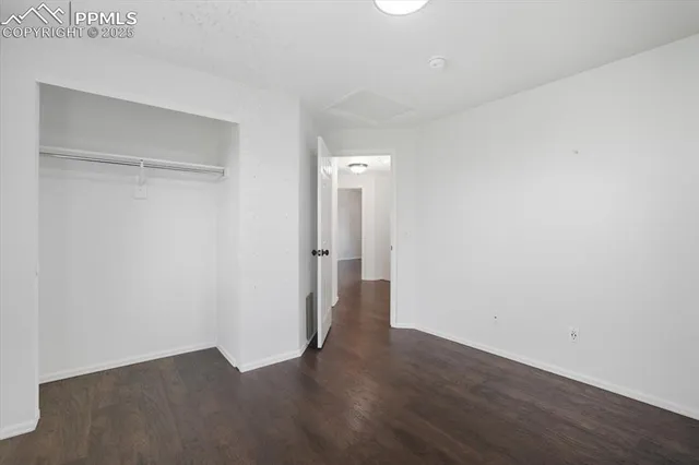 a view of a room with wooden floor