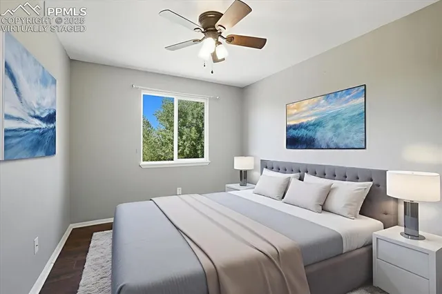 a bedroom with a bed and a painting on the wall