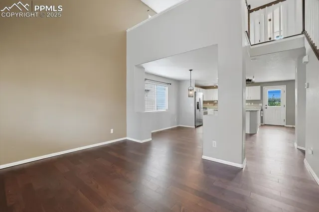a view of a kitchen with wooden floor and a kitchen