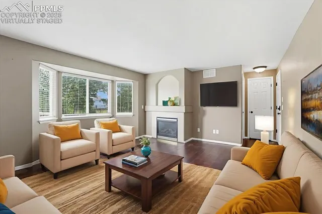 a living room with fireplace furniture and a flat screen tv