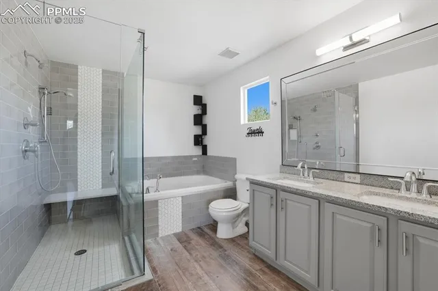 a bathroom with a sink a toilet and shower