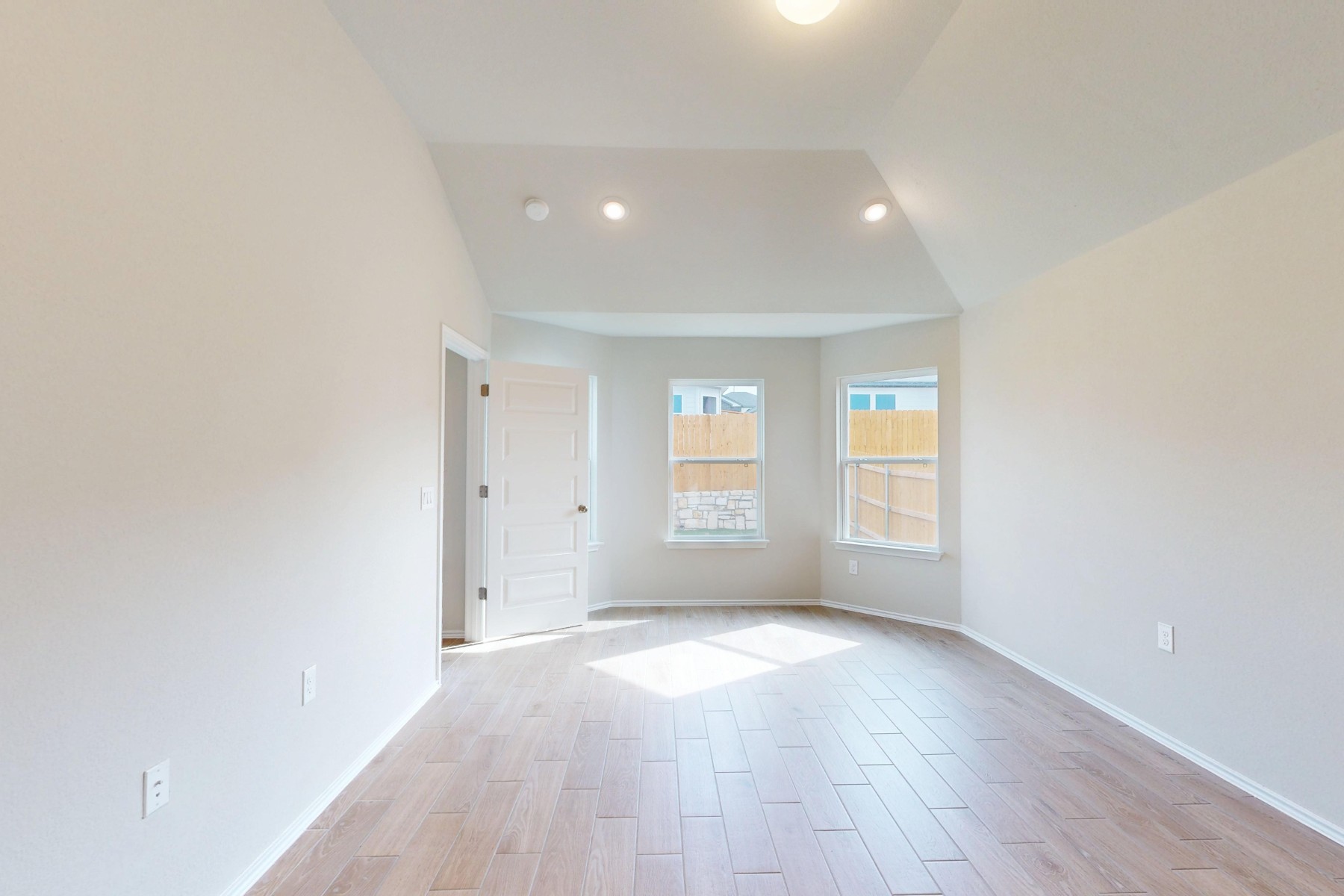 9109 Furman Drive Austin, TX 78747 - Photo 12 of 33 an empty room with wooden floor and windows