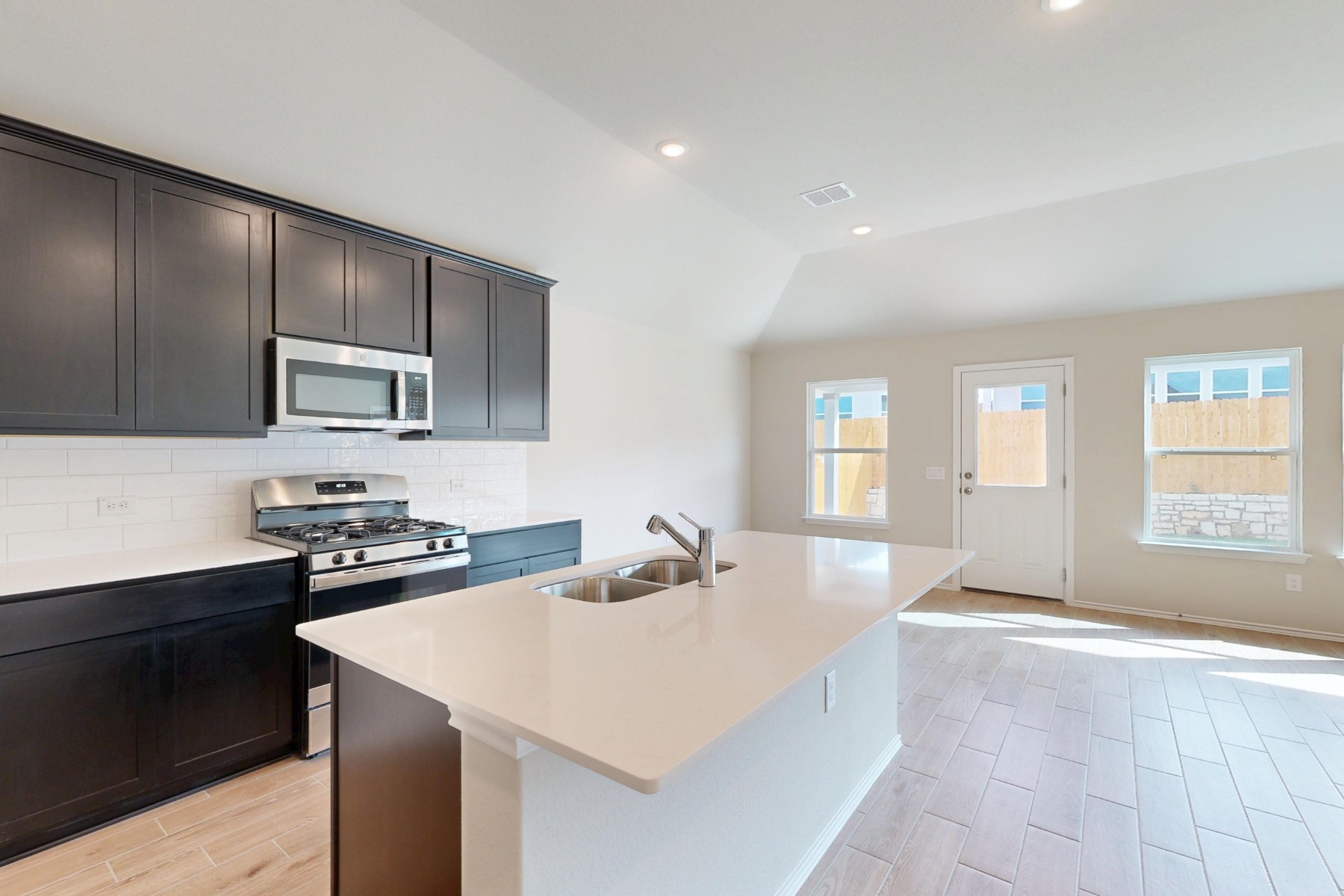 9109 Furman Drive Austin, TX 78747 - Photo 6 of 33 a kitchen with stainless steel appliances a sink stove and cabinets