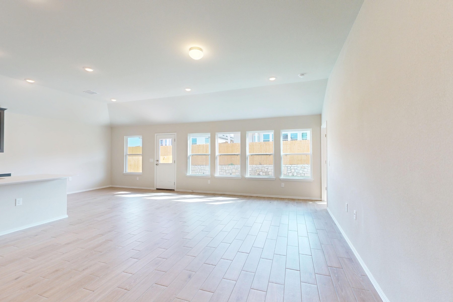 9109 Furman Drive Austin, TX 78747 - Photo 10 of 33 a view of an empty room with a window and wooden floor