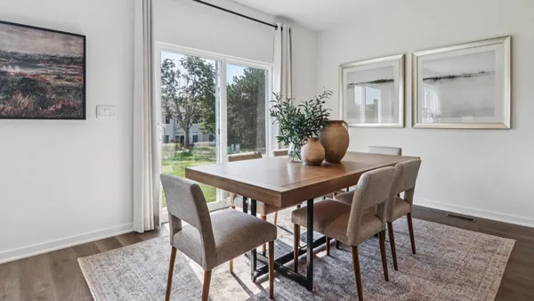 a dining room with furniture and wooden floor