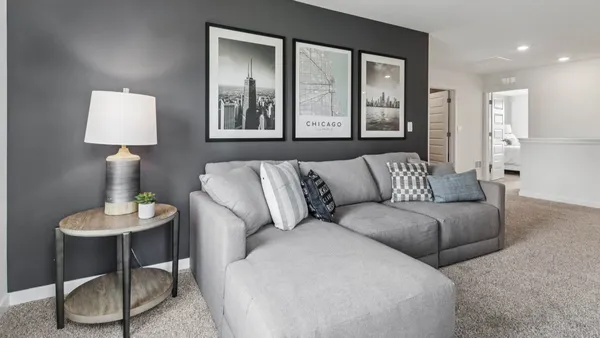 a living room with furniture and a lamp