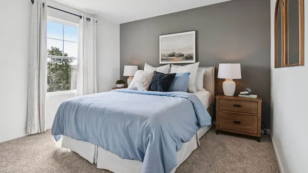 a large bed sitting in a bedroom next to a window