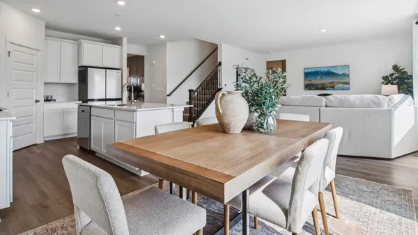 a dining room with furniture and wooden floor