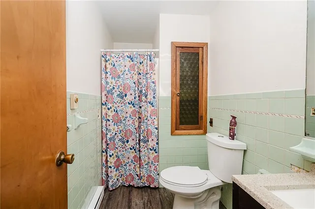 a white toilet sitting next to a bathroom sink