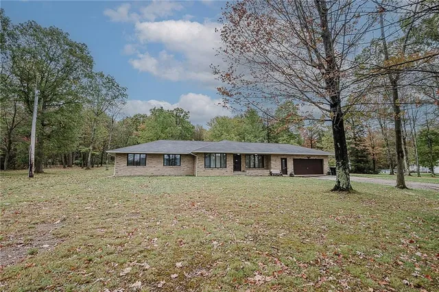 a view of house with a backyard