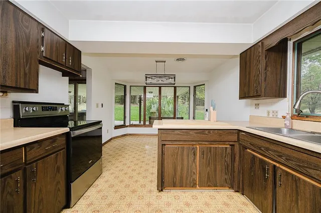 a kitchen with a sink stove and cabinets