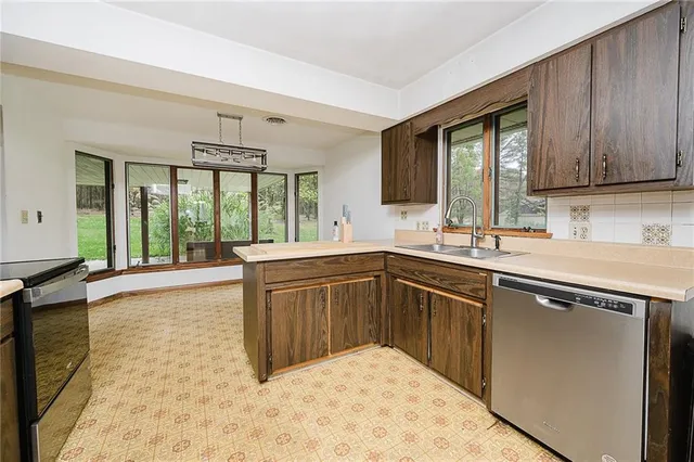a kitchen with a sink and large window