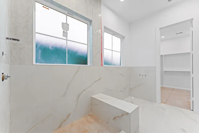 a bathroom with a bathtub and window