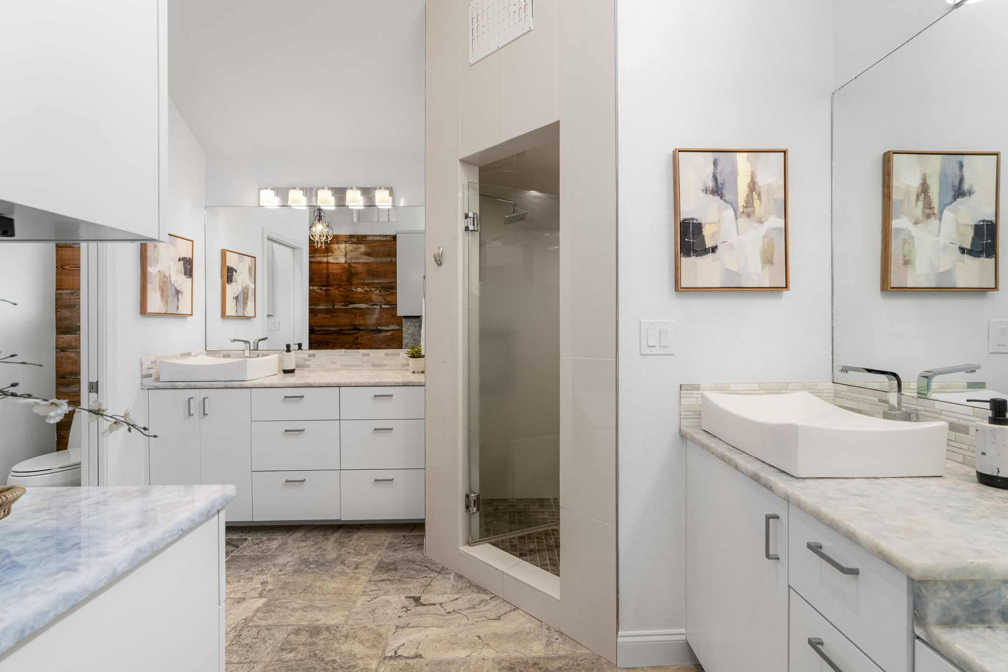 1129 Cedar Pass Road Driftwood, TX 78619 - Photo 23 of 40 The dual vanities with vessel sinks and the massive walk-in shower with a built-in bench make it feel like a five-star resort.