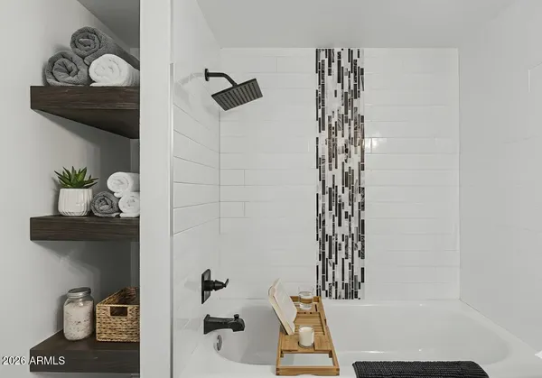 a bathroom with a bathtub and a shower