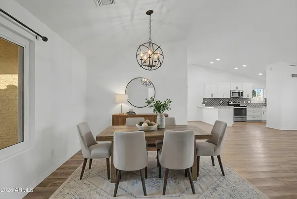 a dining room with furniture a window and wooden floor