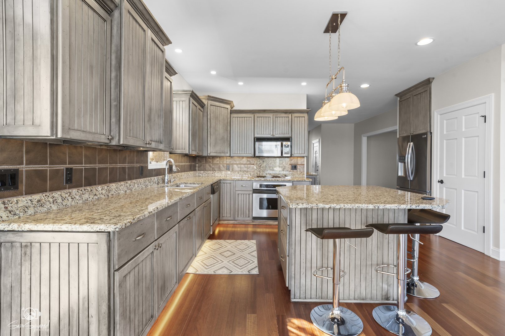 8043 Tamarack Lane Morris, IL 60450 - Photo 19 of 55 a kitchen that has a lot of cabinets in it with stainless steel appliances granite countertop a stove a sink and a refrigerator