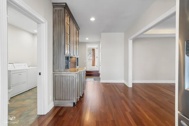 a view of a hallway with wooden floor and a sink
