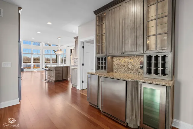 a kitchen with stainless steel appliances granite countertop a refrigerator sink and cabinets