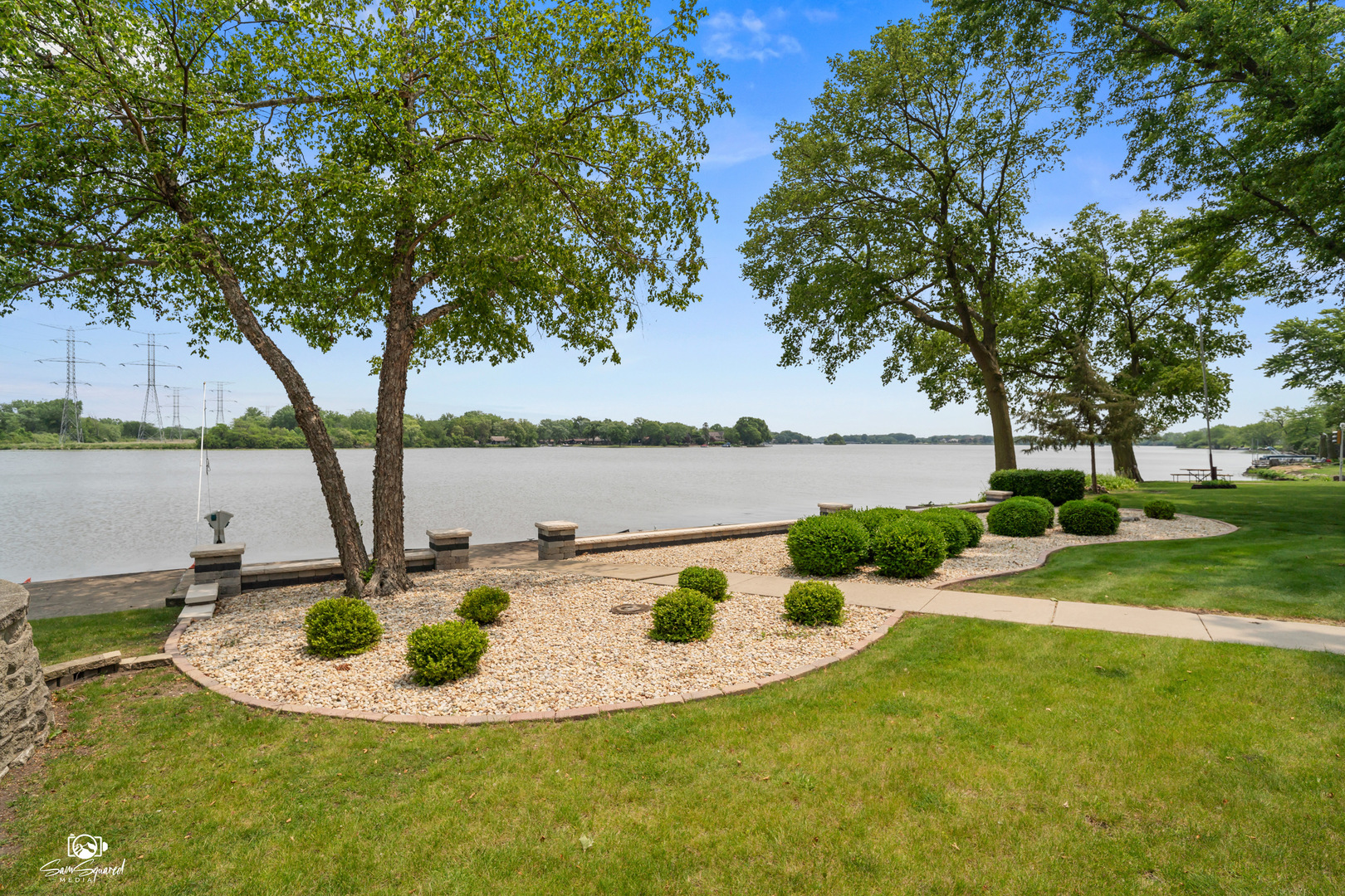 8043 Tamarack Lane Morris, IL 60450 - Photo 3 of 55 a view of a lake with a house in the background