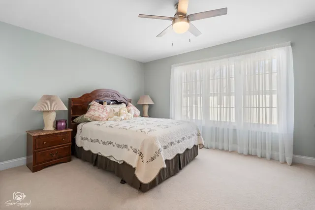 a spacious bedroom with a bed and a chandelier