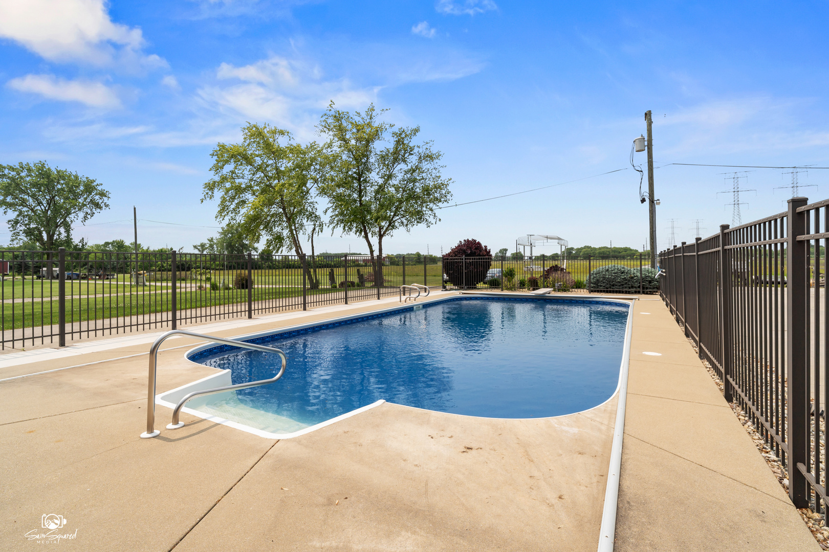 8043 Tamarack Lane Morris, IL 60450 - Photo 48 of 55 a view of a swimming pool with a lake and trees in the background