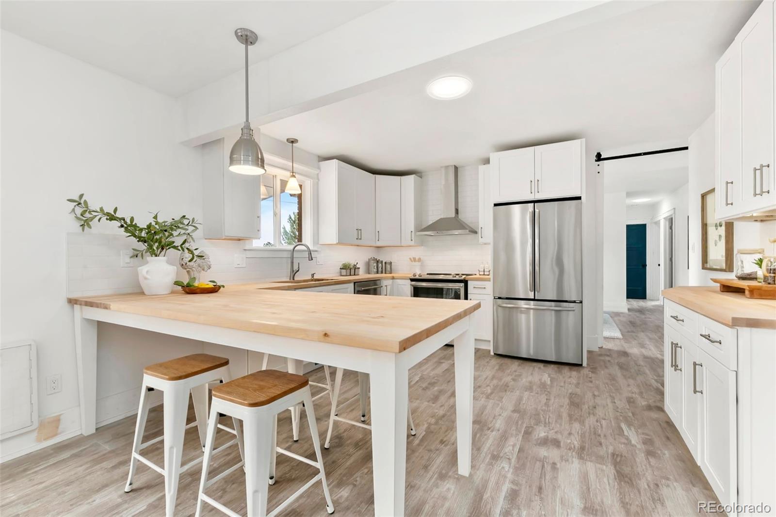 924 Teal Drive Fort Collins, CO 80521 - Photo 11 of 32 a kitchen with white cabinets and white appliances