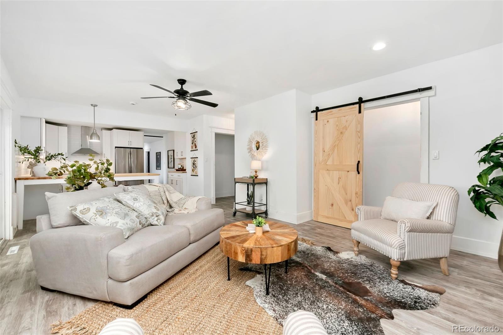 924 Teal Drive Fort Collins, CO 80521 - Photo 15 of 32 a living room with furniture and a chandelier