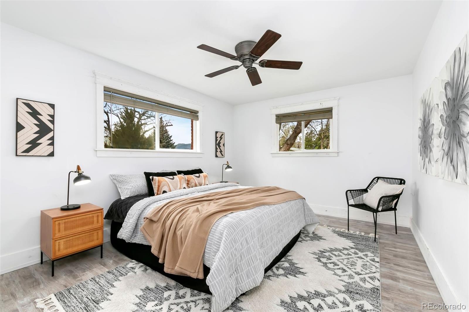 924 Teal Drive Fort Collins, CO 80521 - Photo 16 of 32 a bedroom with a bed and a chandelier