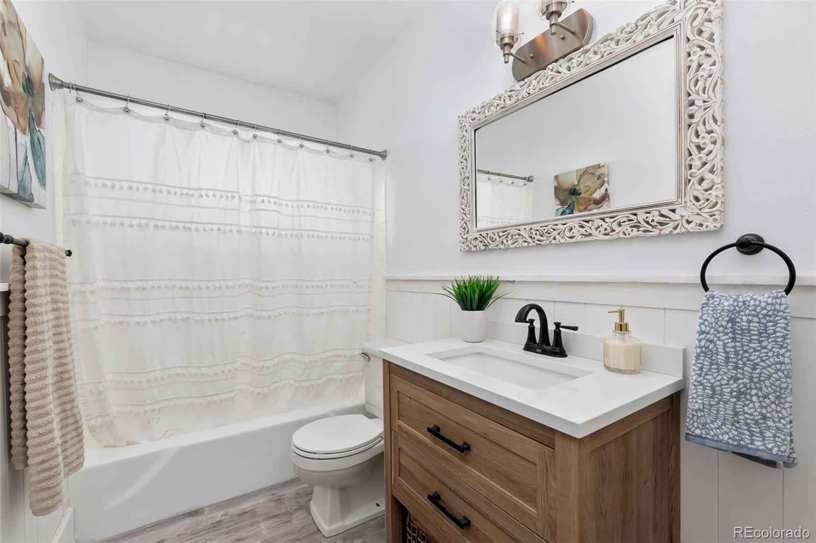 924 Teal Drive Fort Collins, CO 80521 - Photo 18 of 32 a bathroom with a sink a toilet and shower